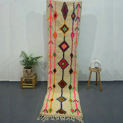A vibrant cream-colored moroccan handmade azilal rug with bold geometric patterns and textured woolen surface by decorbites