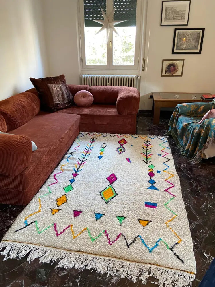 A vibrant cream moroccan handmade azilal berber carpet with colorful geometric patterns supporting sustainable practices