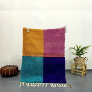 Vibrant plush moroccan handmade beni ouarain rug with color-block design in mustard yellow magenta teal and deep purple with white fringe