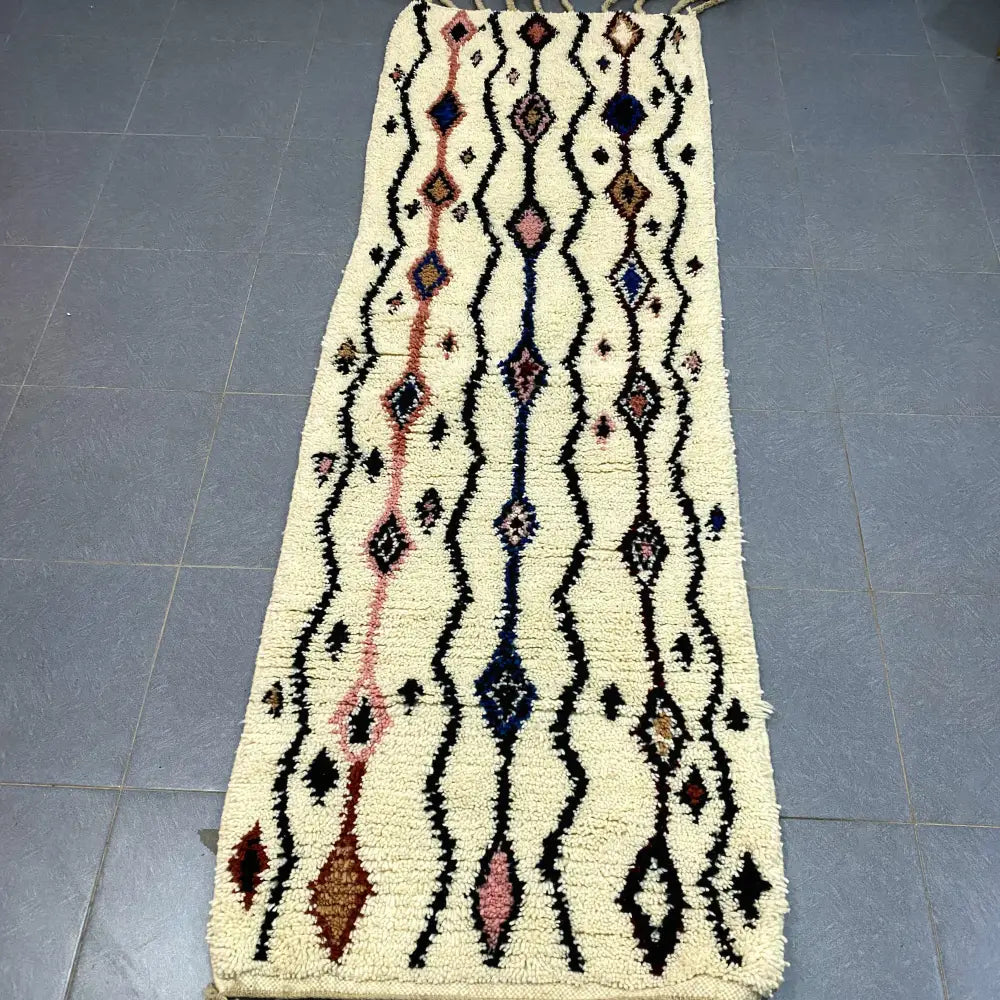 Cream-colored moroccan handmade beni ouarain rug with intricate black pink and navy geometric patterns 2.5m x 0.7m