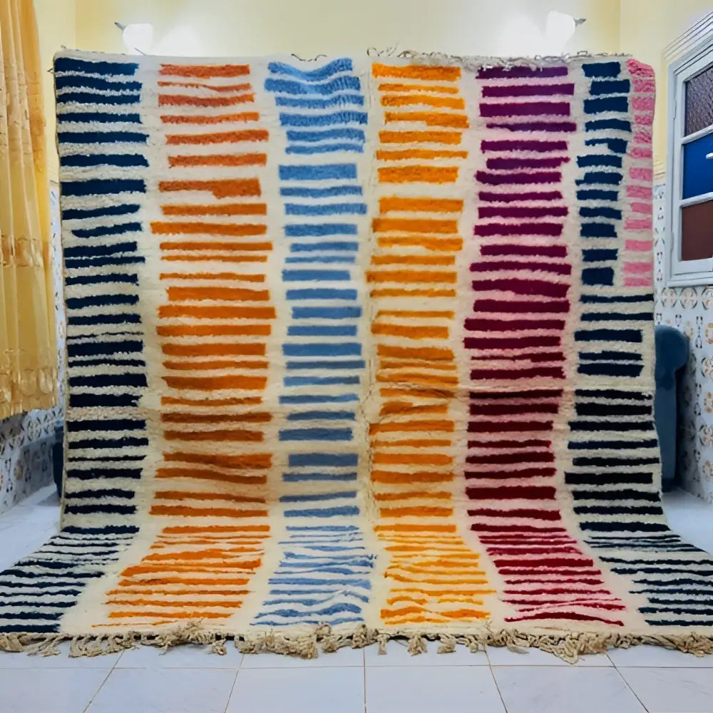 Decorbites™ moroccan handmade beni ouarain wool rug with vibrant blue orange purple and red stripes on cream background