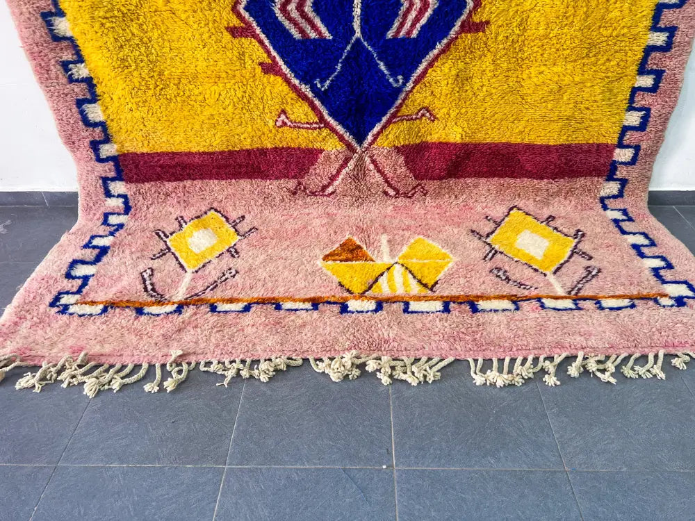 Vibrant pink and yellow moroccan handmade beni ouarain wool rug with bold blue red and white geometric patterns 3m x 2.5m