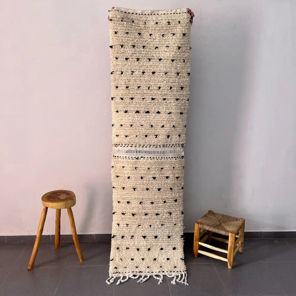 Decorbites moroccan handmade beni ouarain rug with off-white woven texture black dot accents and fringed edge 1m by 70cm
