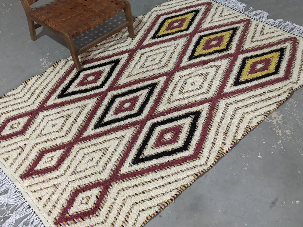 DecorBites™ moroccan handmade traditional azilal rug with cream base, red and black diamonds, yellow centers, and white fringe