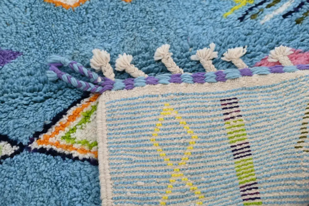 Blue textured decorbites™ moroccan handmade traditional azilal rug with colorful geometric patterns and fringed edges