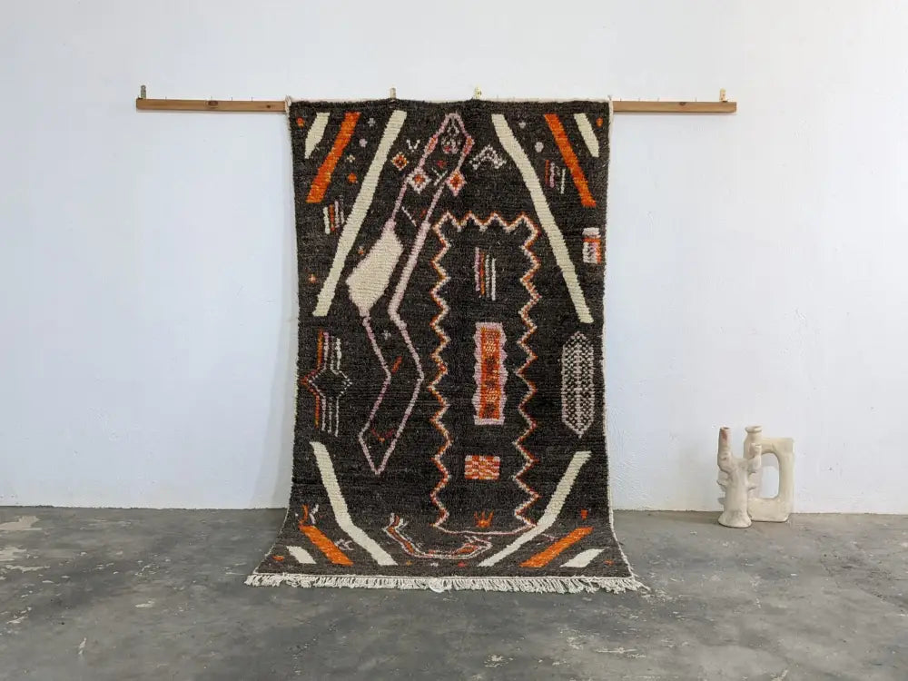 Black woven moroccan handmade azilal rug with bold orange white cream geometric patterns in pure natural wool 244 x 130 cm