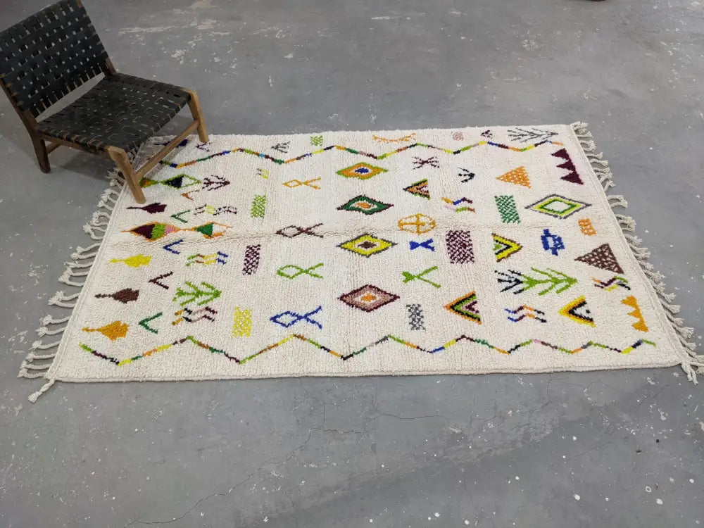 Cream-colored DecorBites™ moroccan handmade traditional azilal rug with vibrant geometric patterns on wool base