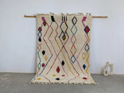 Cream-colored moroccan handmade traditional azilal rug with vibrant pink black blue yellow and red geometric patterns 252 x 160 cm