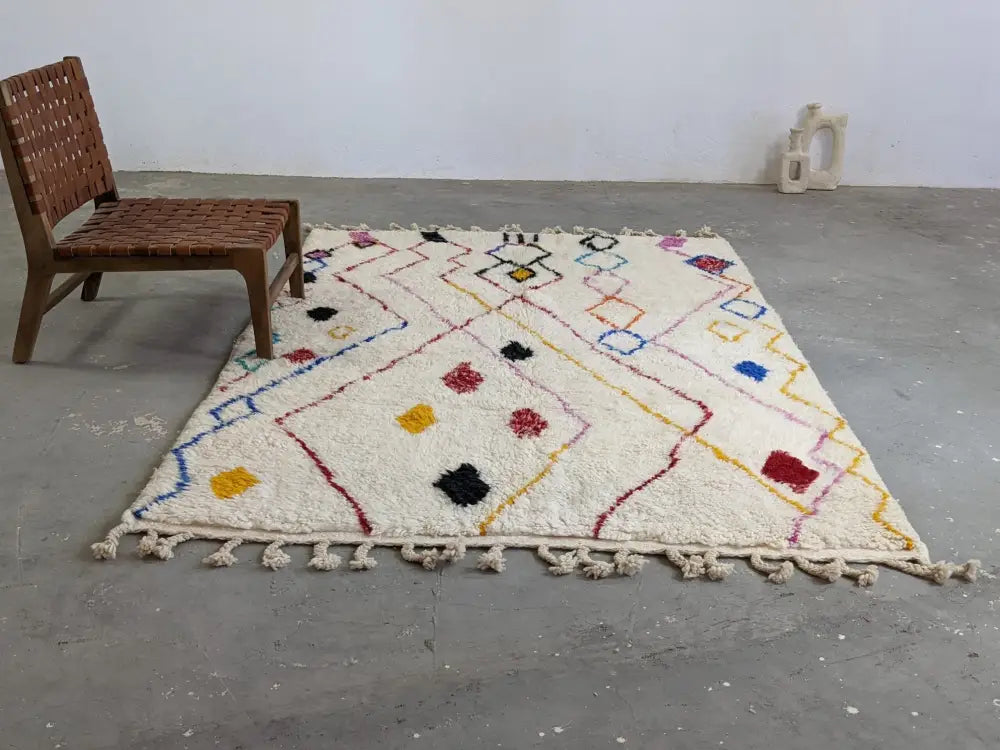 Cream-colored moroccan handmade traditional azilal rug with colorful geometric patterns and fringed woolen texture 252 x 160 cm