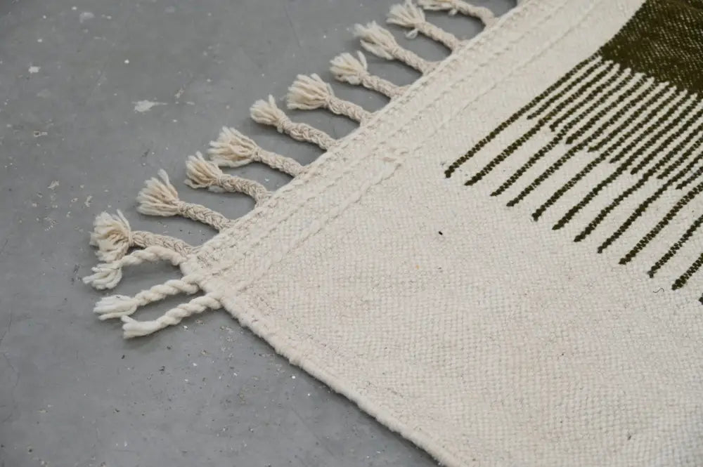 Cream-colored woven moroccan handmade traditional azilal rug with olive green stripes and fringed edge 253 x 145 cm