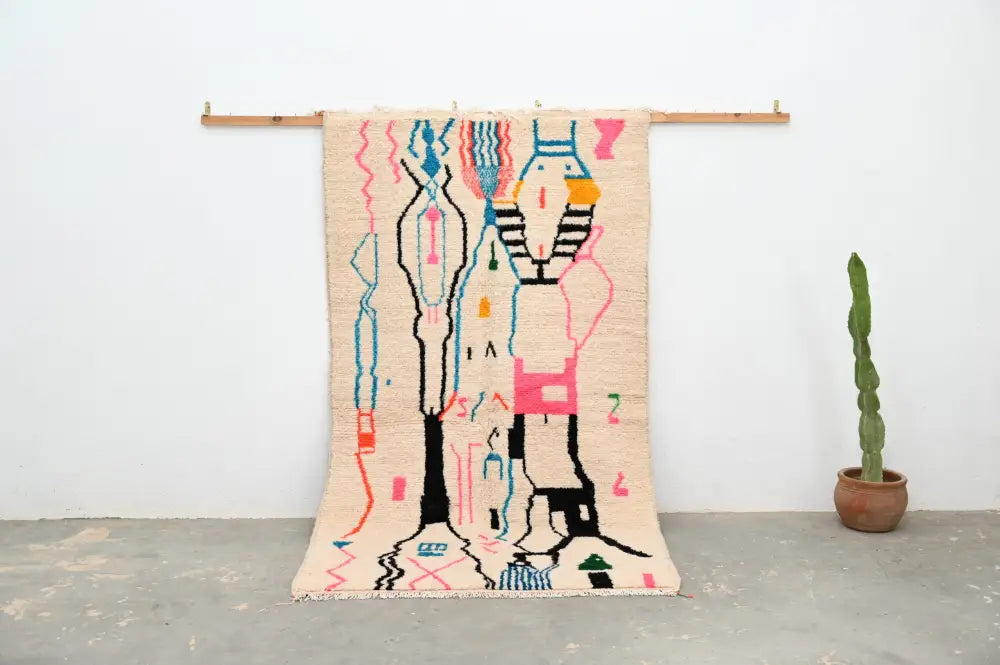 Beige woven decorbites™ moroccan handmade traditional azilal rug with vibrant pink, blue, black, and orange geometric patterns