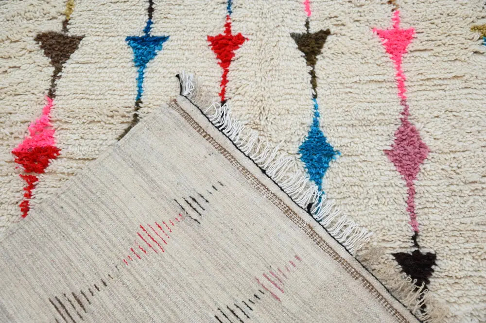 Beige moroccan handmade traditional azilal rug with colorful red blue pink and brown geometric patterns by DecorBites™