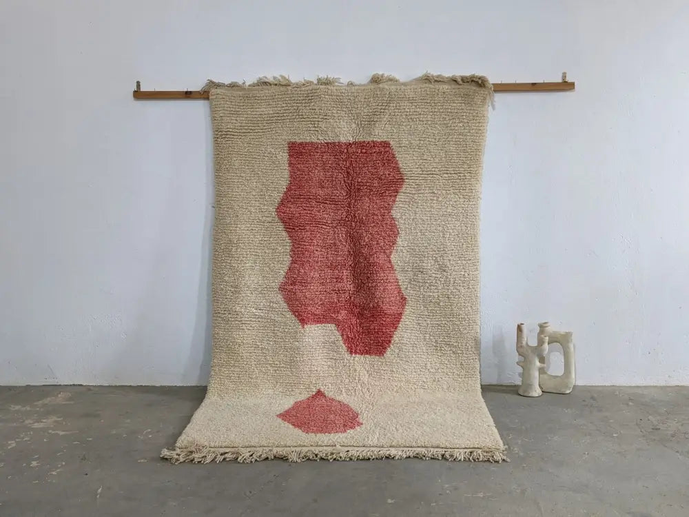 Beige woven moroccan handmade traditional azilal rug with bold red abstract leaf design and fringed edges 255 x 155 cm