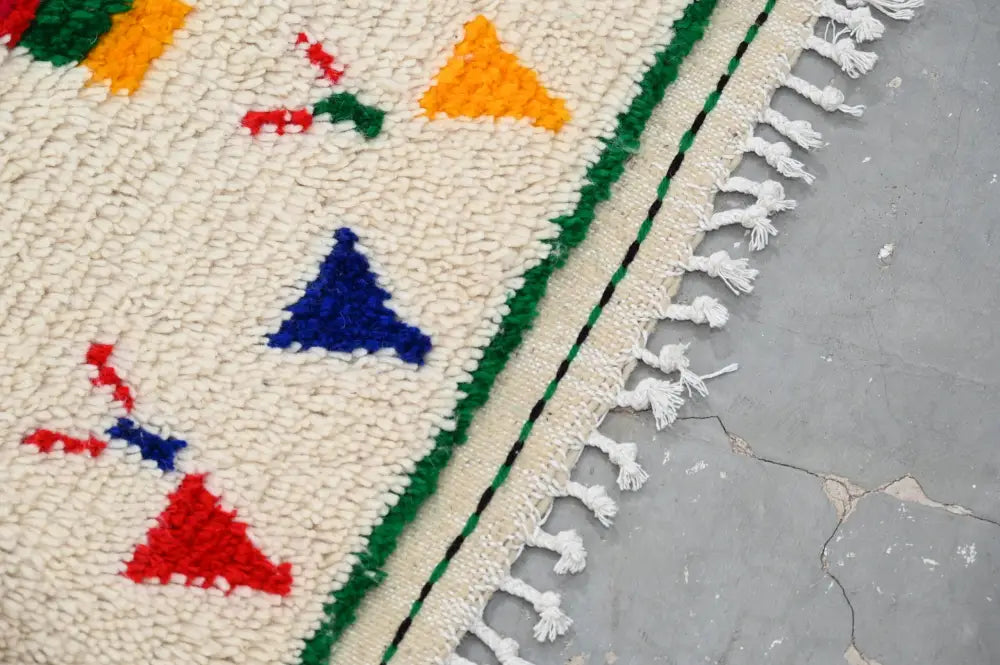 Cream-colored DecorBites™ moroccan handmade traditional azilal rug with bold red blue and orange geometric woolen patterns