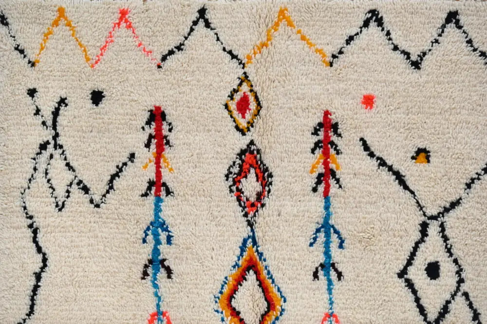 Cream-colored moroccan handmade traditional azilal rug with bold black orange red and blue geometric patterns 260 x 145 cm