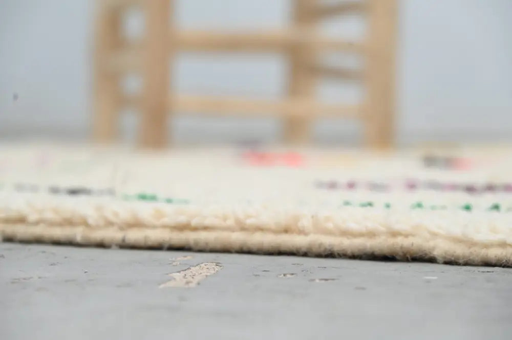 Beige moroccan handmade traditional azilal rug with woven texture, fringed edges, and subtle multicolored patterns, 260 x 148 cm