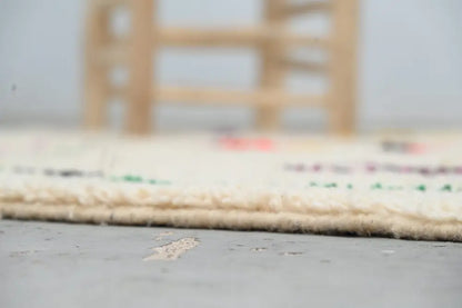 Beige moroccan handmade traditional azilal rug with woven texture, fringed edges, and subtle multicolored patterns, 260 x 148 cm