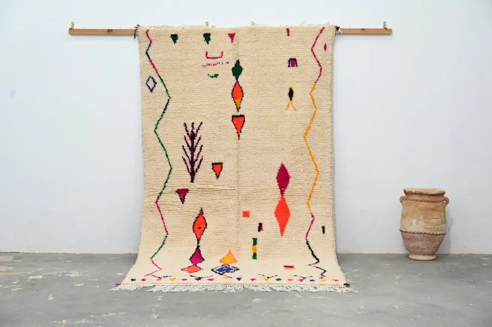 Beige moroccan handmade traditional azilal rug with vibrant red orange green and purple geometric patterns 260 x 148 cm