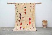 Beige moroccan handmade traditional azilal rug with vibrant red orange green and purple geometric patterns 260 x 148 cm