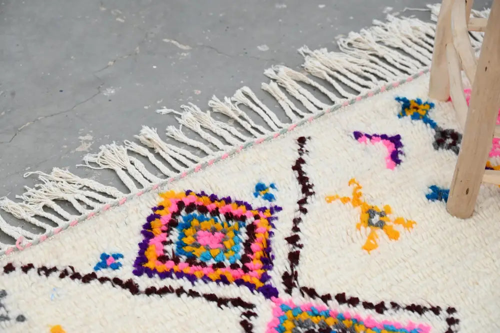 A vibrant moroccan handmade traditional azilal rug by DecorBites with cream base and bold multicolor geometric patterns