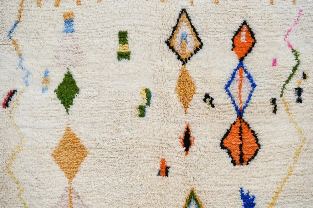 Cream-colored DecorBites™ moroccan handmade traditional azilal rug with plush texture and vibrant geometric patterns