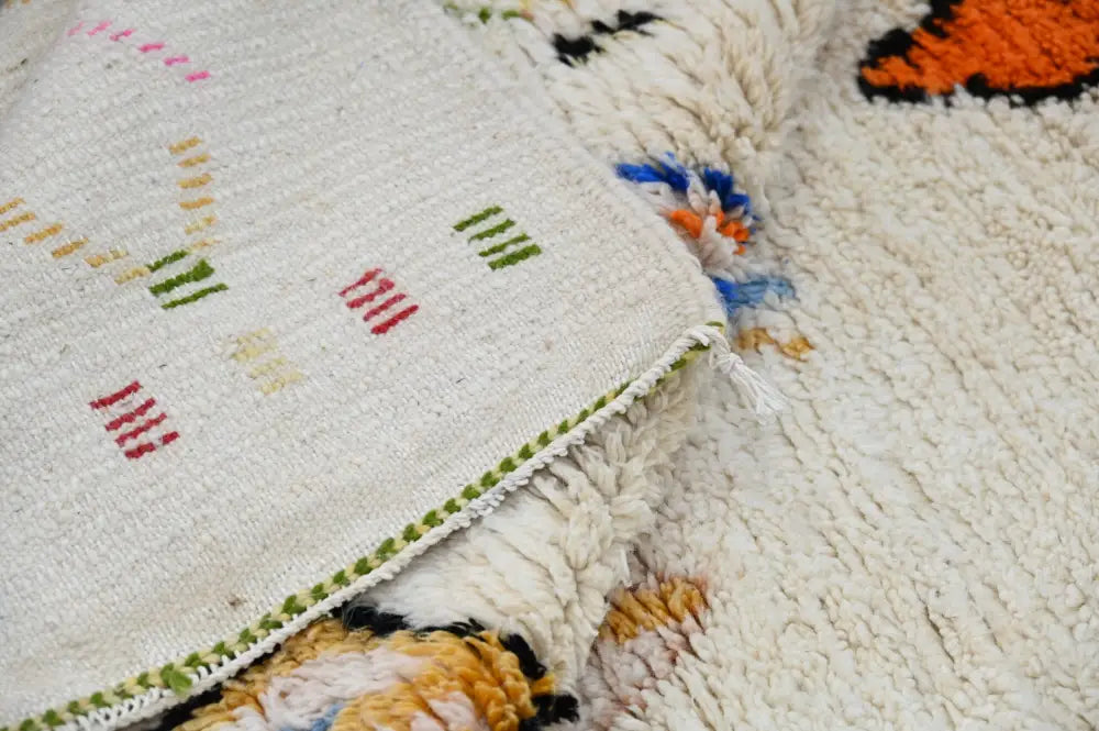 Cream-colored decorbites™ moroccan handmade traditional azilal rug with intricate red green and yellow geometric patterns 261 x 143 cm