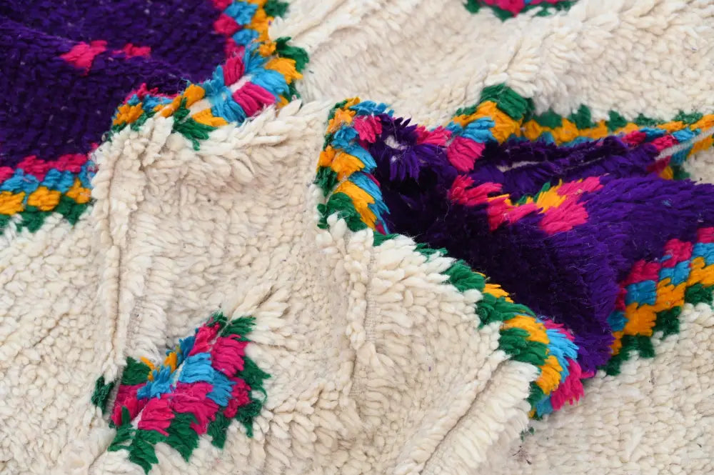 DecorBites™ moroccan handmade traditional azilal rug with plush cream wool base and vibrant purple pink green patterns