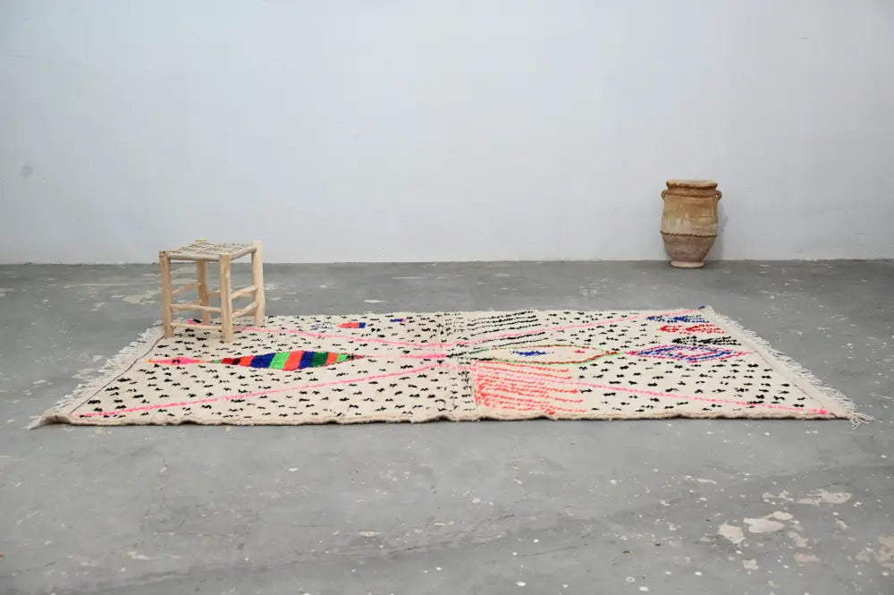 Beige moroccan handmade traditional azilal rug with black polka dots and colorful geometric patterns by DecorBites