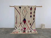 Beige moroccan handmade azilal rug with bold red blue and purple geometric patterns in pure natural wool 265x161 cm