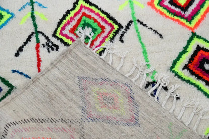 Vibrant moroccan handmade traditional azilal rug featuring colorful geometric squares on cream wool with fringed edges