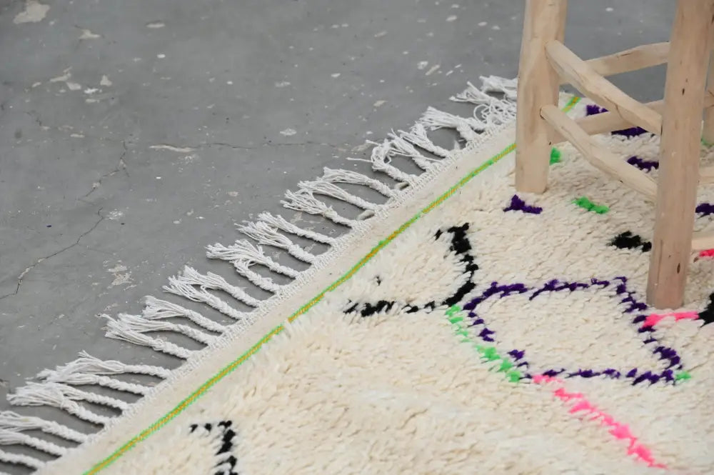 Decorbites™ moroccan handmade traditional azilal rug cream color with bold black purple green pink geometric patterns and fringed edges