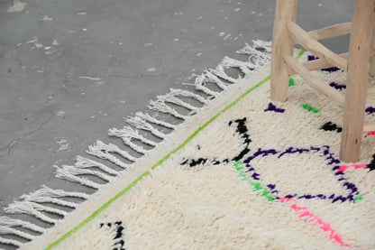 Decorbites™ moroccan handmade traditional azilal rug cream color with bold black purple green pink geometric patterns and fringed edges