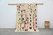 Beige moroccan handmade traditional azilal rug with vibrant pink purple green and black geometric patterns 274 x 145 cm