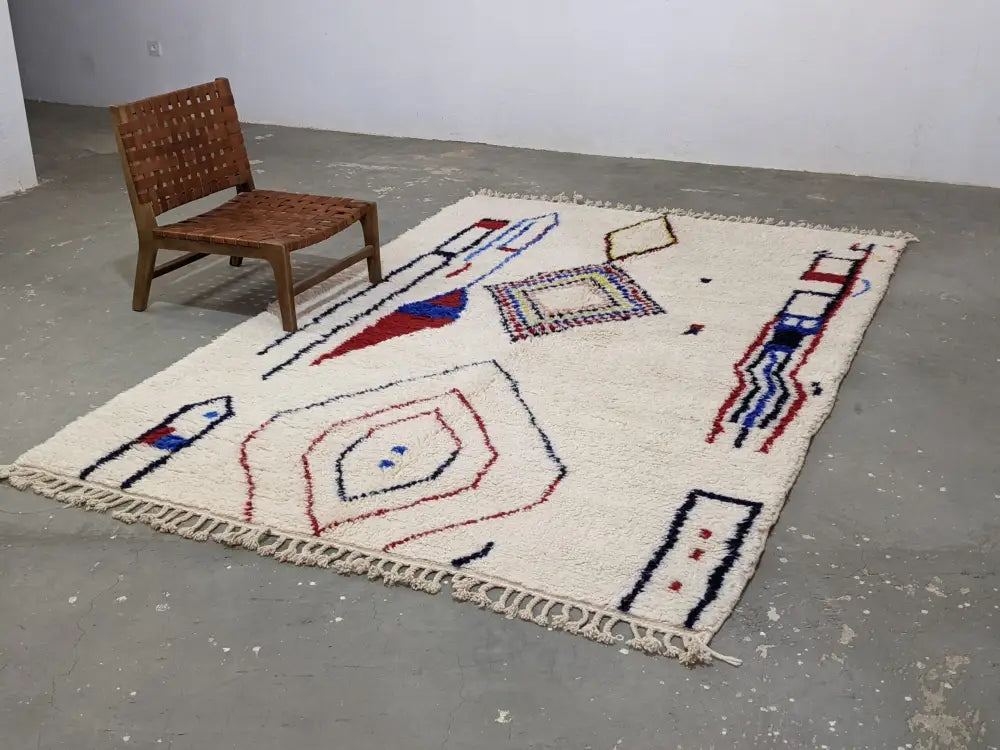 Cream-colored moroccan handmade traditional azilal rug with red blue and black geometric wool patterns 300 x 200 cm