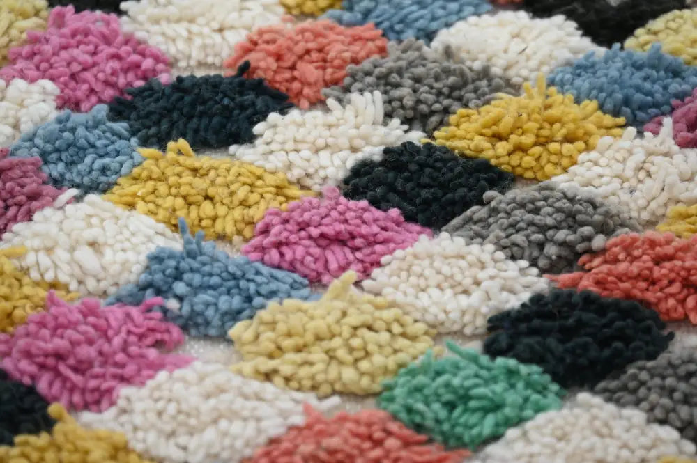 Colorful moroccan handmade traditional azilal rug with fluffy yarn clusters in pink yellow blue gray black and white