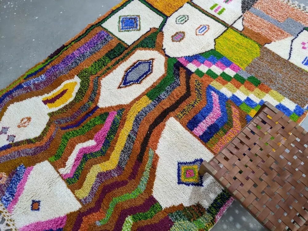 Vibrant moroccan handmade traditional azilal rug in multicolored wool with bold geometric patterns and fringe by DecorBites