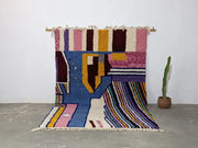 Vibrant moroccan handmade traditional azilal rug with bold pink blue yellow purple and brown wool geometric patterns 304x210 cm