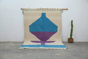 Beige woven moroccan handmade traditional azilal rug with bold turquoise purple geometric design and blue fringe 307 x 196 cm