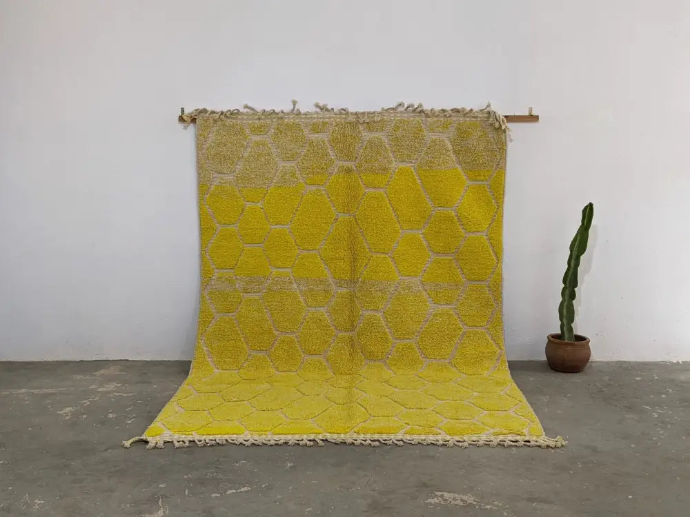 Vibrant yellow moroccan handmade traditional azilal rug with textured honeycomb pattern and natural fiber fringe