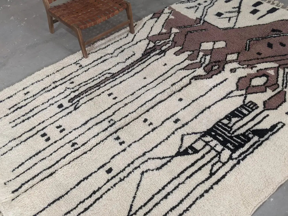Cream-colored wool moroccan handmade traditional azilal rug with bold black and brown geometric patterns 317 x 215 cm