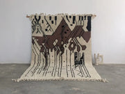 Beige and brown geometric-patterned moroccan handmade traditional azilal rug with black accents and fringed edges by DecorBites