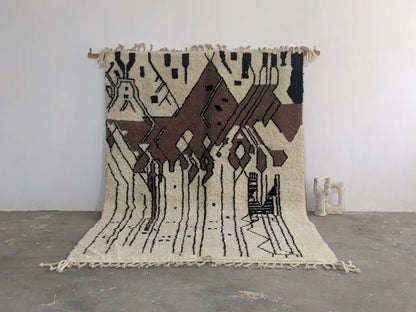 Beige and brown geometric-patterned moroccan handmade traditional azilal rug with black accents and fringed edges by DecorBites