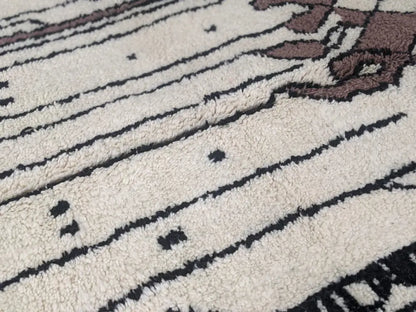 Cream-colored plush wool moroccan handmade traditional azilal rug with bold black and brown geometric patterns