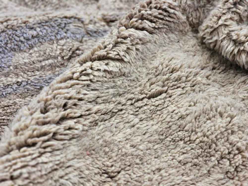 Beige plush fleece blanket with soft texture and gray patterns featured in moroccan handmade beni mrirt rug design