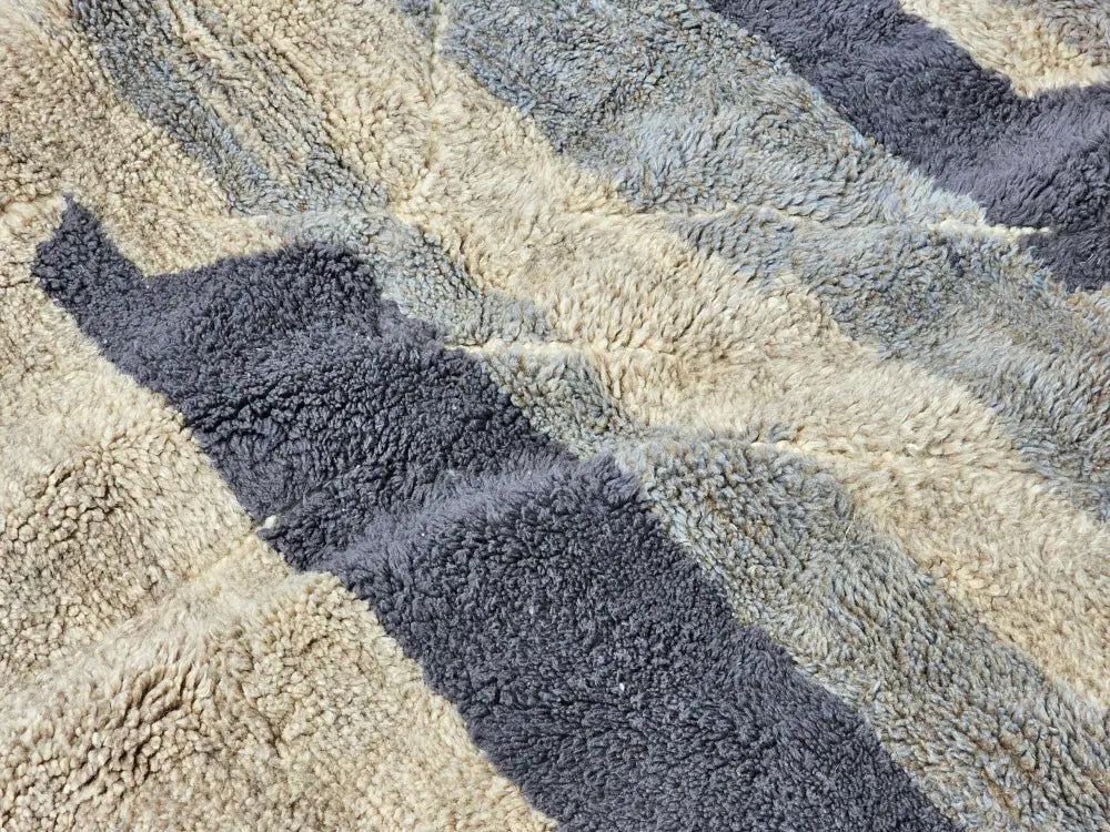 A plush textured moroccan handmade beni mrirt rug with diagonal cream and dark gray stripes 330 x 323 cm