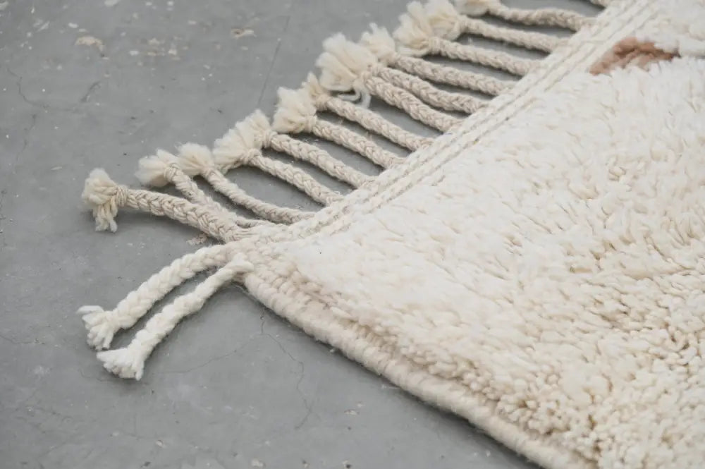 Cream-colored plush wool beni ouarain moroccan handmade rug with textured surface and tasseled fringe 283 x 211 cm
