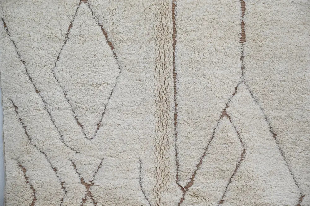 Cream-colored plush wool beni ouarain rug with brown geometric stitched diamonds by DecorBites moroccan handmade design