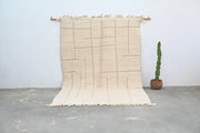 Beige woven beni ouarain carpet with geometric pattern and fringed edges moroccan handmade beni ouarain rug