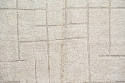 Beige textured moroccan handmade beni ouarain carpet with raised rectangular grid pattern 305 x 202 cm by decorbites