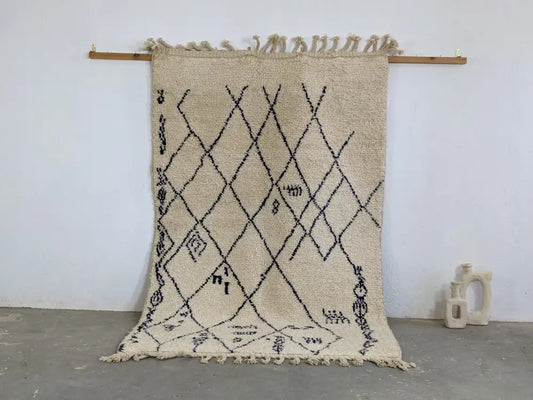 Beige moroccan handmade beni ouarain rug with black geometric patterns and fringed edges 244 x 157 cm